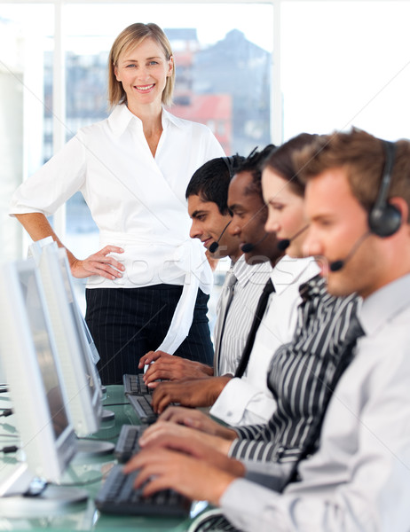 Delighted female leader managing her concentrated team in a call center Stock photo © wavebreak_media