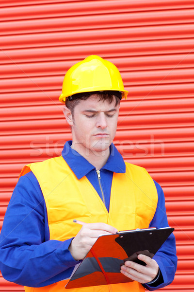 Handsome male engineer writing his report  Stock photo © wavebreak_media