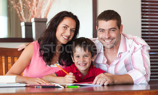 Cute boy sitting between his parents at the table Stock photo © wavebreak_media
