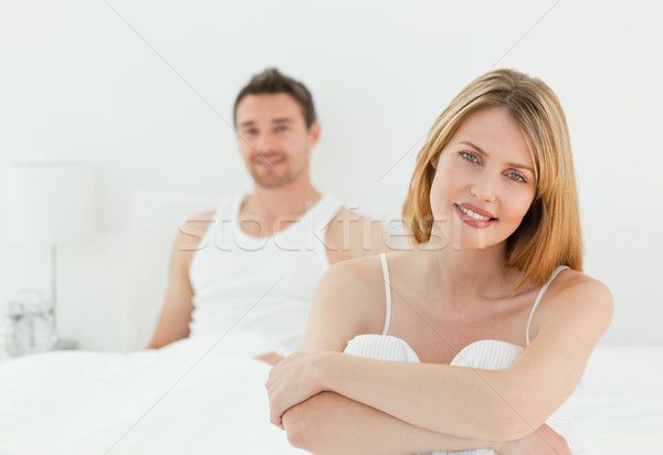 Superb woman looking at the camera with her husband at home Stock photo © wavebreak_media