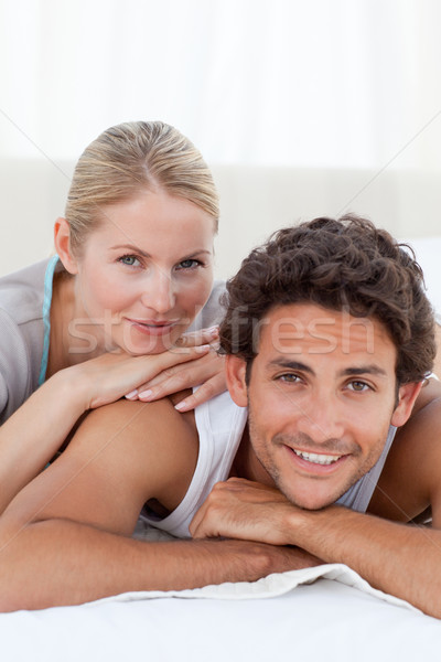 Beautiful couple lying down on their bed at home Stock photo © wavebreak_media