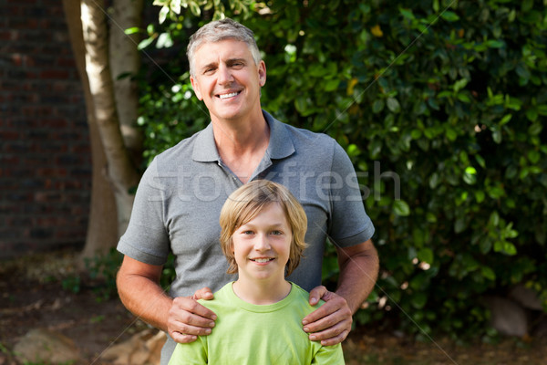 Father and his son looking at the camera in the garden Stock photo © wavebreak_media