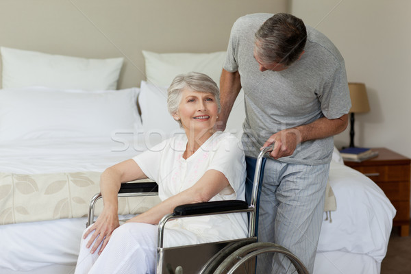 Retired woman in her wheelchair with her husband Stock photo © wavebreak_media