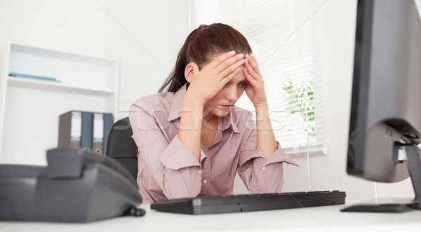 A frustrated businesswoman sitting in her office Stock photo © wavebreak_media