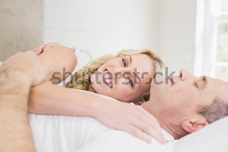 Angry woman awaken by her boyfriend's snoring in their bedroom Stock photo © wavebreak_media