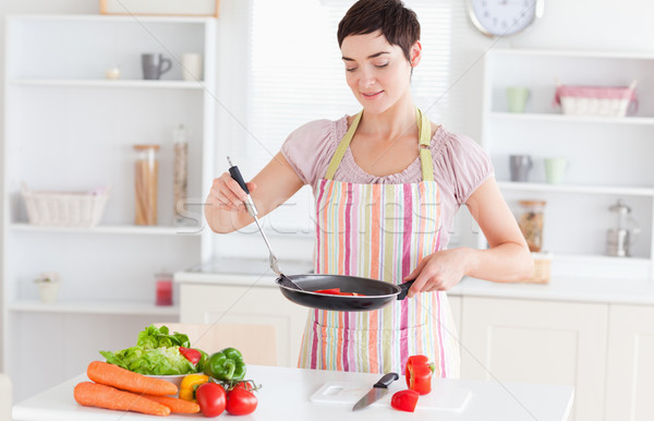 Stock photo: Cute woman cooking in the kitchen