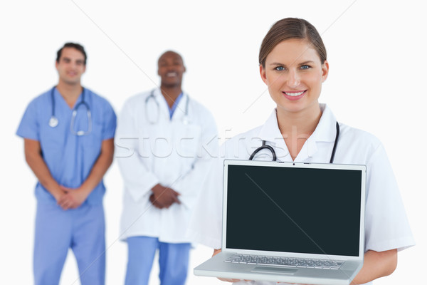 Souriant médecin portable collègues derrière [[stock_photo]] © wavebreak_media