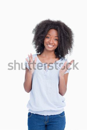 Woman raising her hands as an indication of happiness against a white background Stock photo © wavebreak_media