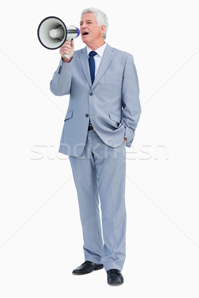 Businessman shouting with megaphone against white background Stock photo © wavebreak_media