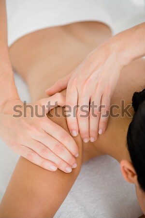 Serious practitioner using his fist to work on the knees of a patient indoors Stock photo © wavebreak_media