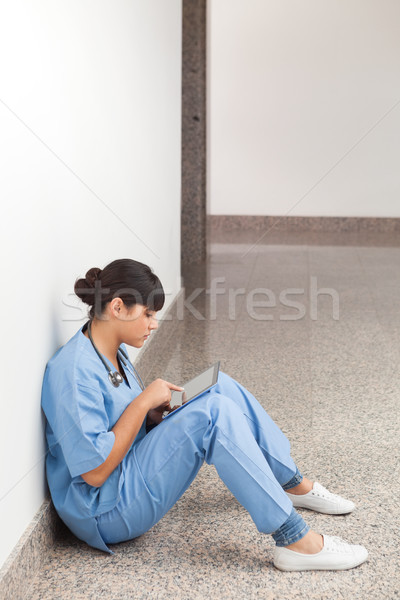 Nurse using computer tablet in hospita corridor Stock photo © wavebreak_media