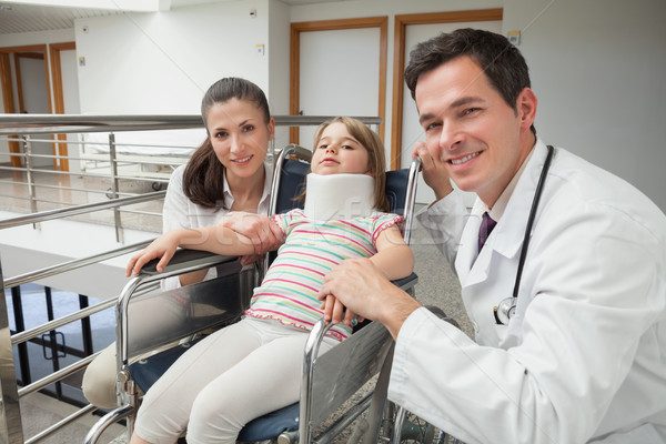 Smiling doctor, mother and her child with neckbrace in wheelchair Stock photo © wavebreak_media