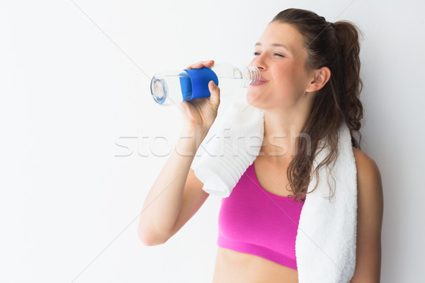 Uśmiechnięty młoda kobieta ręcznik woda pitna biały wody Zdjęcia stock © wavebreak_media