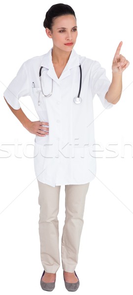 Pretty brown haired nurse pointing Stock photo © wavebreak_media