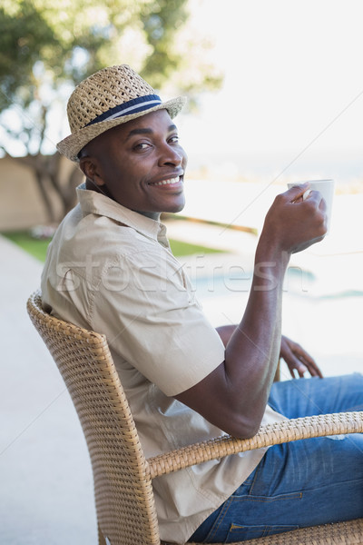 Smiling man relaxing in his garden having coffee Stock photo © wavebreak_media