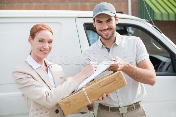 Delivery driver handing parcel to customer outside van Stock photo © wavebreak_media