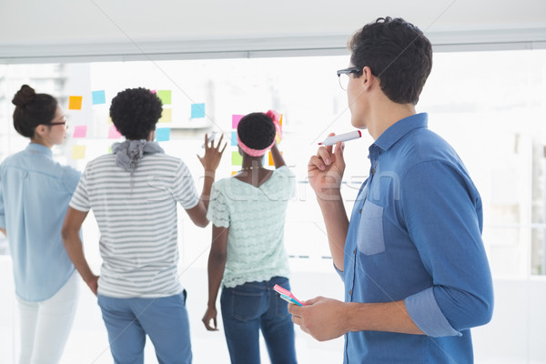 Stock photo: Young creative man looking at team