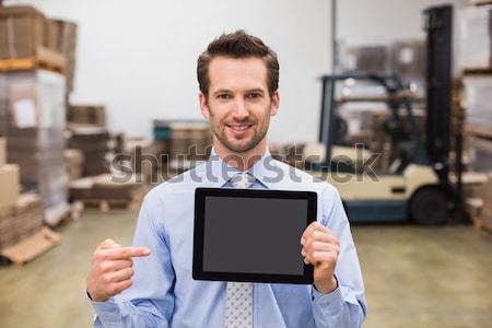 Stock photo: Warehouse manager showing tablet pc smiling at camera