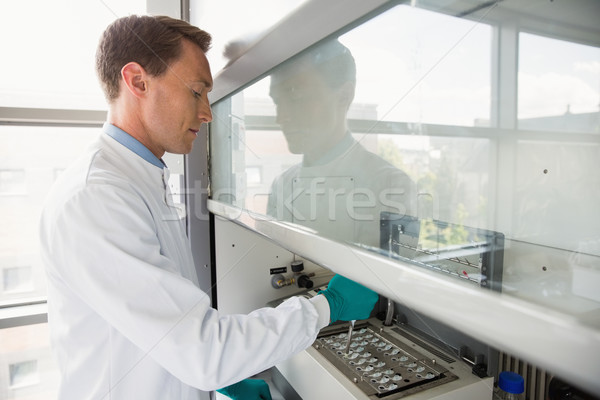 Young scientist using a pipette in chamber Stock photo © wavebreak_media