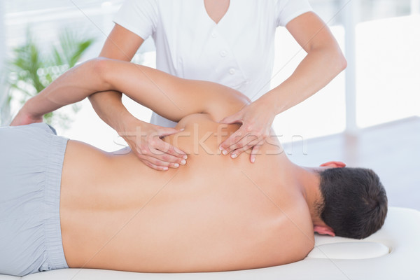 Stock photo: Physiotherapist doing back massage to her patient