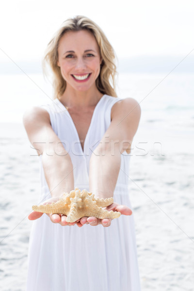 улыбаясь блондинка белое платье Starfish пляж Сток-фото © wavebreak_media