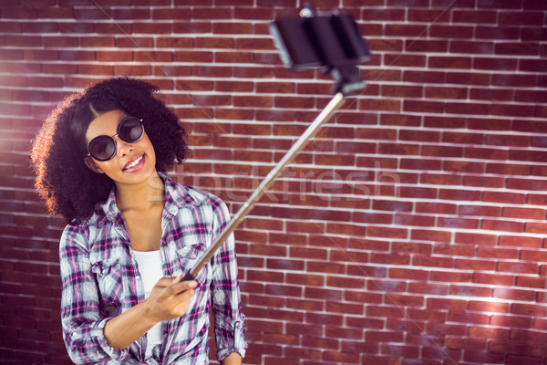 Attractive hipster taking selfies with selfiestick Stock photo © wavebreak_media