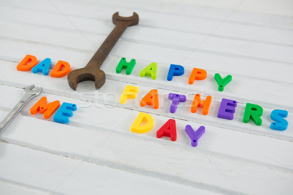 Rusty wrench by multi colored happy fathers day text on table Stock photo © wavebreak_media