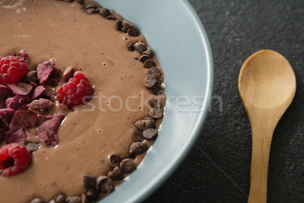 Jarabe de chocolate frutas tazón negro primer plano mano Foto stock © wavebreak_media