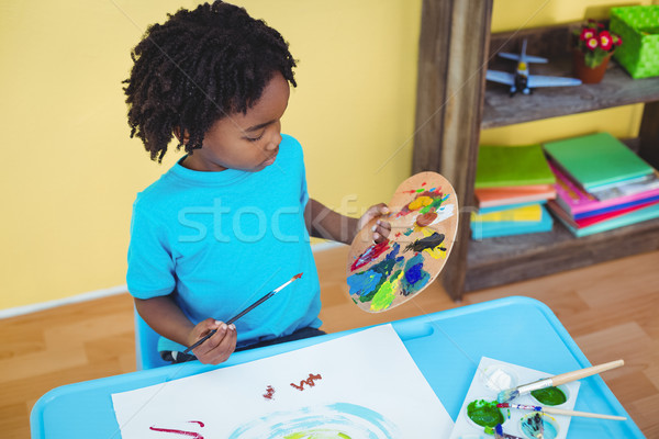 Child using paints to make a picture Stock photo © wavebreak_media