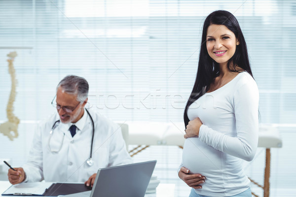 Pregnant woman with doctor at clinic Stock photo © wavebreak_media