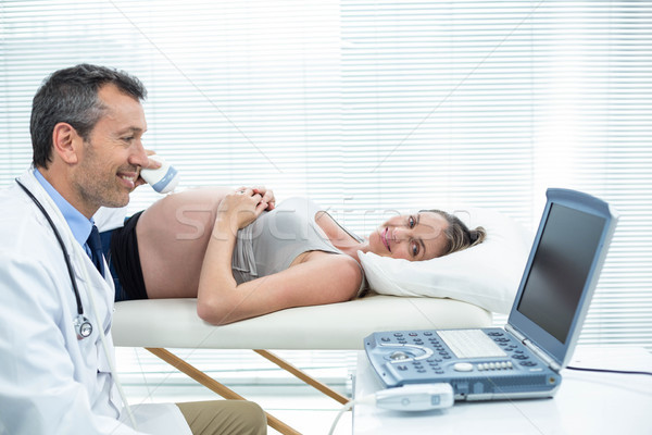 Pregnant woman receiving ultrasound treatment Stock photo © wavebreak_media