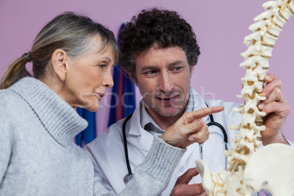 Physiotherapist explaining the spine model to patient Stock photo © wavebreak_media