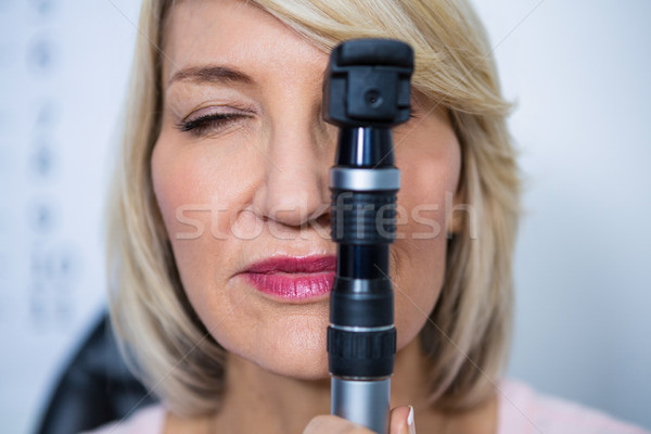 Female patient looking through ophthalmoscope Stock photo © wavebreak_media