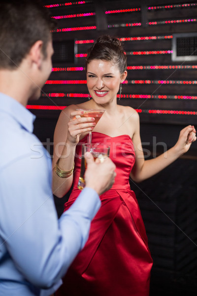 Smiling couple holding glass of beer and cocktail while dancing Stock photo © wavebreak_media