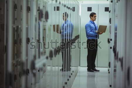 Technician using laptop while analyzing server Stock photo © wavebreak_media