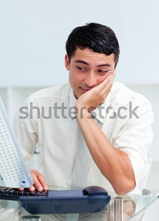 Stock photo: Bored young businessman at his desk