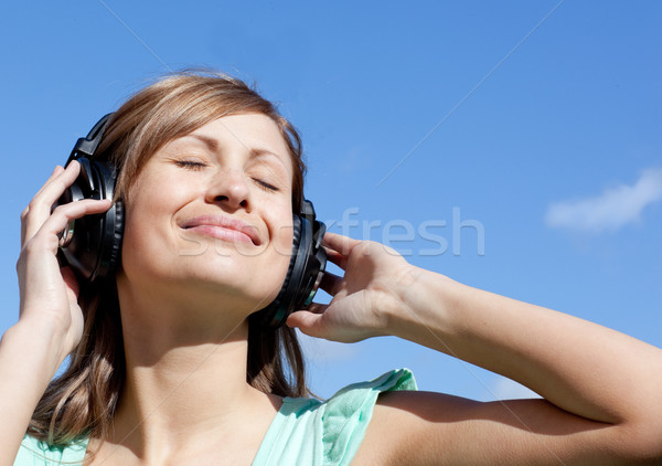 Relaxed woman is listening music outdoor Stock photo © wavebreak_media