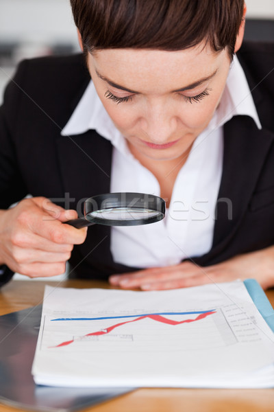 Empresária olhando traçar lupa escritório negócio Foto stock © wavebreak_media