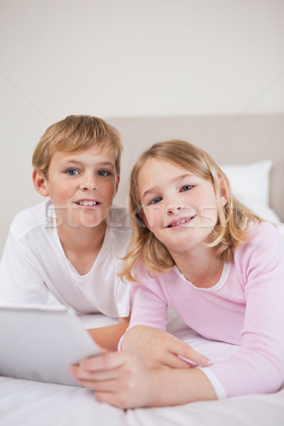 Portrait of children using a tablet computer in a bedroom Stock photo © wavebreak_media