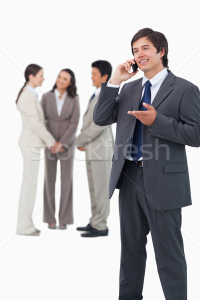 Tradesman talking on the phone with team behind him against a white background Stock photo © wavebreak_media