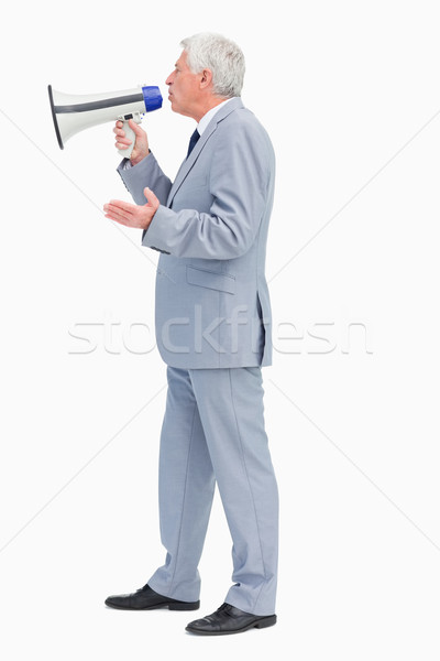 Profile of a businessman speaking with megaphone against white background Stock photo © wavebreak_media