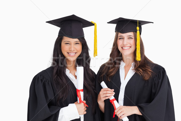 Two friends smile and look at the camera as they are both graduating Stock photo © wavebreak_media