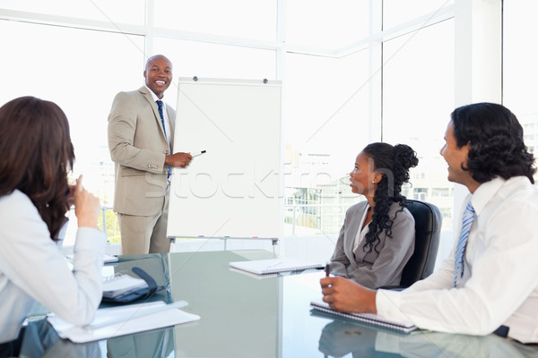 Smiling young businessman giving a presentation Stock photo © wavebreak_media