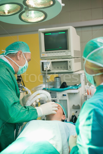 Surgeon putting an oxygen mask on a patient Stock photo © wavebreak_media