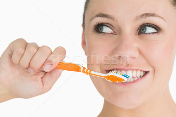 Cute woman washing her teeth in the white background Stock photo © wavebreak_media
