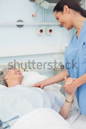 Obstetrician talking to a smiling pregnant patient Stock photo © wavebreak_media
