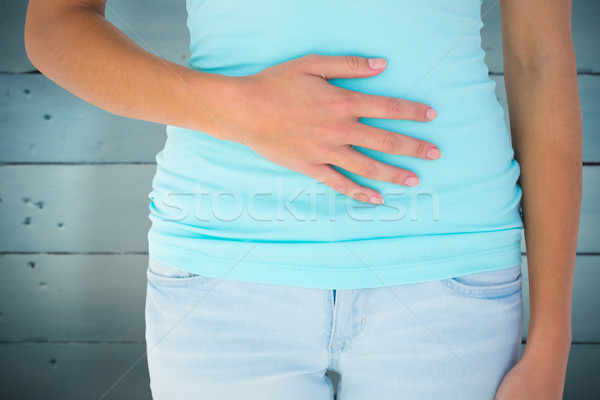 Composite image of slim woman with hand on stomach Stock photo © wavebreak_media