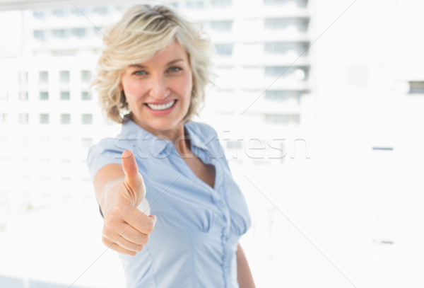 Stock photo: Elegant businesswoman gesturing thumbs up