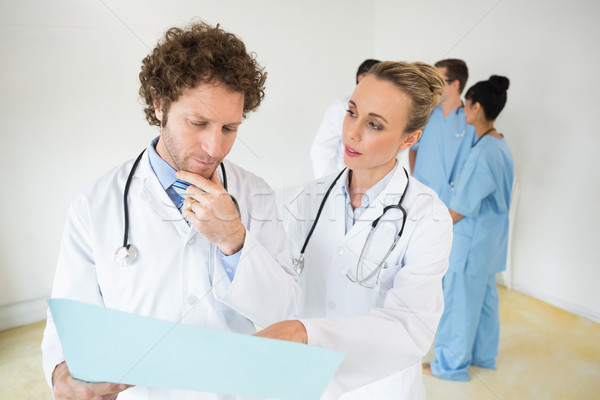 Doctors analyzing file in hospital Stock photo © wavebreak_media