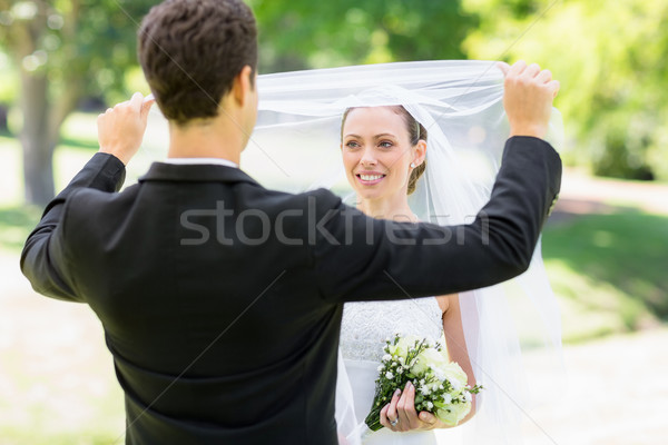 Loving groom lifting veil of bride Stock photo © wavebreak_media